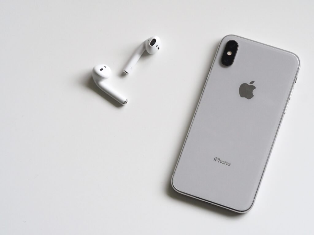 silver iphone and earpods