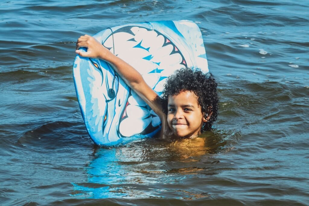 a young boy swimming in the sea