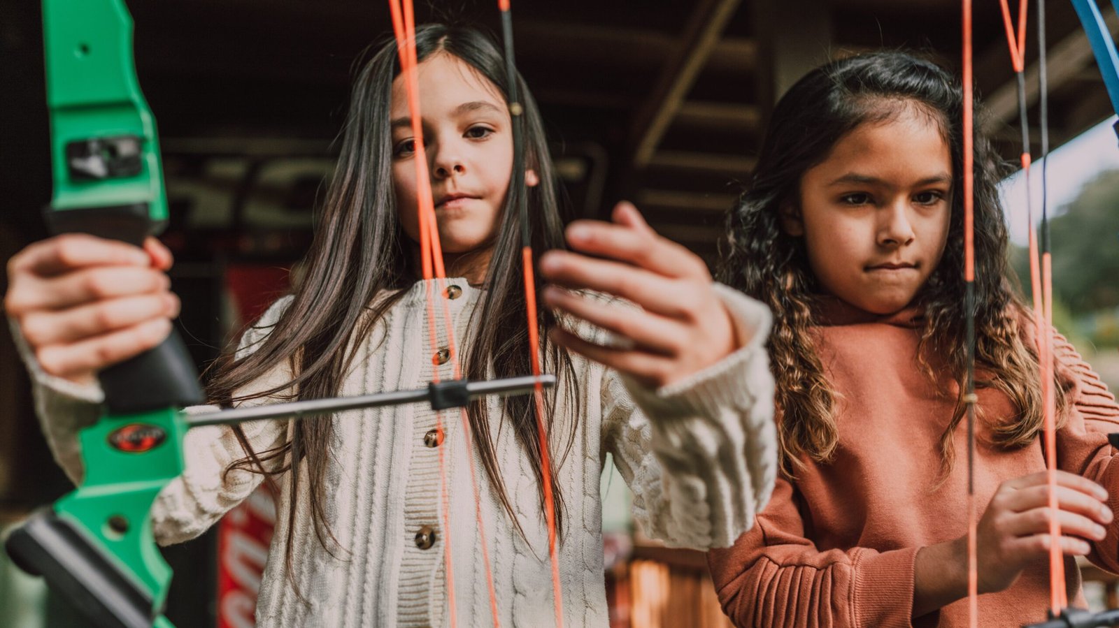 two girls doing archery